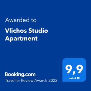 a blue sign with the text awarded to vikos studio apartment at Vlichos Studio Apartment in Hydra