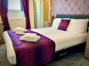 a hotel room with a bed with towels on it at Royal Carlton Hotel in Blackpool