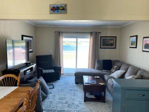 a living room with a couch and a table at Rocky Harbour Oceanfront in Rocky Harbour