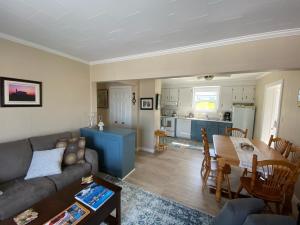 a living room with a couch and a table at Rocky Harbour Oceanfront in Rocky Harbour