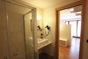a bathroom with a sink and a mirror at Enclos de Moro - Apartments Berthod in Courmayeur +29 photos