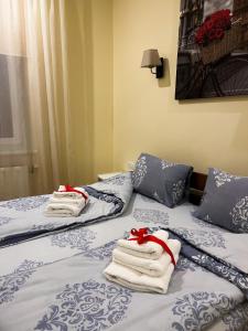 two beds in a room with towels on them at Homey apartment on Vicheva Str. in Lviv