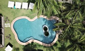uma vista sobre uma piscina com palmeiras em Omali São Tomé em São Tomé