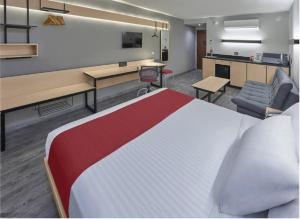 a hotel room with a large bed and a desk at Hotel Best Place Express in Zamora de Hidalgo