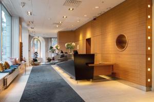 a lobby with a couch and a desk in a building at Elite Hotel Stockholm Plaza in Stockholm