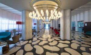 a large lobby with a large chandelier in a building at Medplaya Hotel Pez Espada in Torremolinos