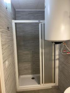 a shower with a glass door in a bathroom at Pension El Dorado in Alicante +46 photos