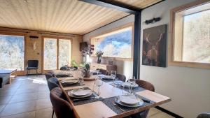 a dining room with a long table and chairs at Chalet BAS-THEX 8-10 pers SAINT JEAN D'AULPS- PROCHE MORZINE-WIFI in Seytroux +18 photos