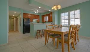 a kitchen and dining room with a table and chairs at Americana Princess Suites/Condos in Ocean City