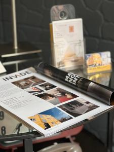 a pen sitting on top of a magazine on a table at Suites & Apartments DP VFXira in Vila Franca de Xira