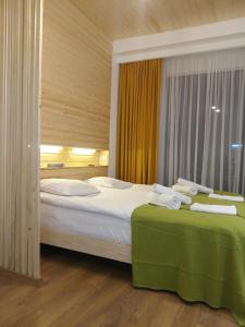 a bedroom with a large bed with towels on it at Roshka Apartment 307 in Gudauri