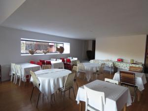 a restaurant with white tables and chairs and a window at Paco de Pombeiro - Turismo de Habitacao in Felgueiras