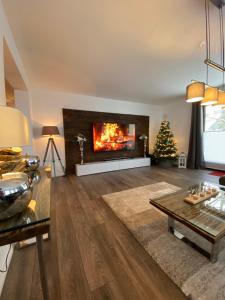 a living room with a fireplace and a christmas tree at Ferienkomfortwohnung Walter in Braunlage