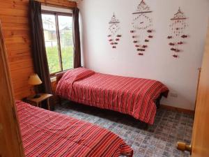 a room with two beds and clocks on the wall at Casa Algarrobo Playa El Canelillo - El Canelo - Piscina in Algarrobo +9 photos