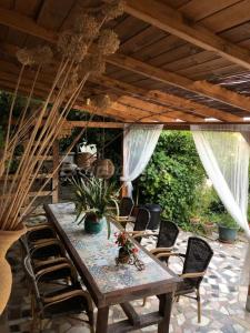 a wooden table and chairs on a patio at Casa Rural La ilusion in Málaga