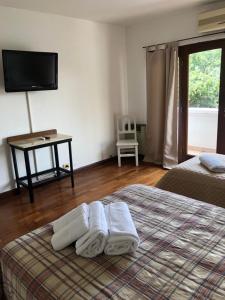 a bedroom with a bed with towels on it at Departamento zona residencial CON PILETA in Salta