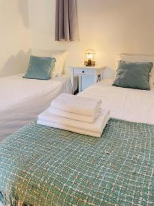 a bed with a white comforter and two pillows at Porto Smart Apartments- airport in Perafita