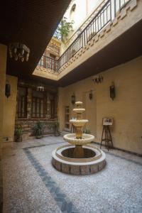 a fountain in the middle of a room with a building at Gamaleya Boutique Hotel in Cairo