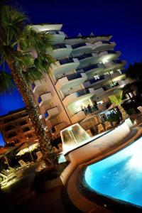a large building with a swimming pool next to a hotel at Residence Oltremare in San Benedetto del Tronto