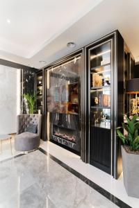 a dining room with a display case and a chair at Merit Kensington Hotel in London