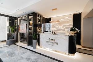 a fashion store with a counter in a lobby at Merit Kensington Hotel in London