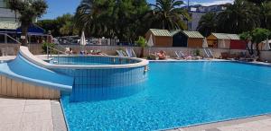 a swimming pool with a slide in a resort at Hotel Soraya in San Benedetto del Tronto