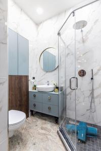a bathroom with a sink and a shower at Lovely apartment Traku str. in Vilnius
