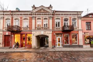 a building on a street with people walking in front at Lovely apartment Traku str. in Vilnius