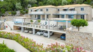 an aerial view of a house with a parking lot at Thealos Village aparthotel Lefkada in Lygia