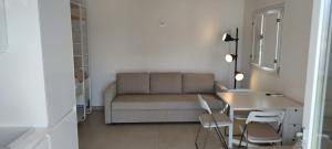 a living room with a couch and a table and chairs at Fèdeli House Pool in Noto
