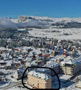 an aerial view of a city with snow covered buildings at Apartment Sailor in Žabljak