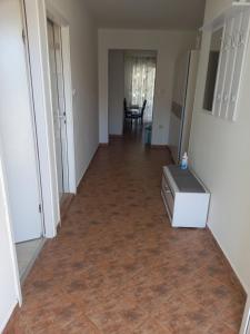 an empty hallway with a kitchen and a refrigerator at Apartmani Ivana in Lopar