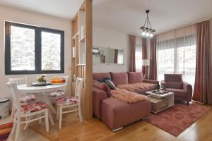 a living room with a couch and a table at Apartman Tea - Zlatibor in Zlatibor