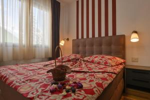 a bedroom with a bed with a basket on it at Apartman Tea - Zlatibor in Zlatibor