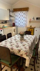 a dining room table with a floral table cloth on it at Ocean Front View in Angra do Heroísmo