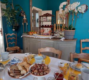 a table with a plate of food on it at Domaine de Rateau in Bayas