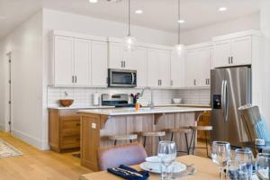een keuken met witte kasten en een roestvrijstalen koelkast bij Villa 25! Brand New Luxury 4 bedroom Villa! in St. George