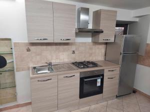 a kitchen with a sink and a stove top oven at Casa M&M: Campobasso in Campobasso