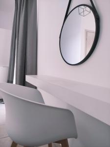 a white table with a mirror on a wall at Alkyon Hotel in Parikia