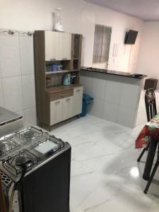 a kitchen with a stove top oven in a room at Apartamento bem localizado na Av.Principal in Manaus
