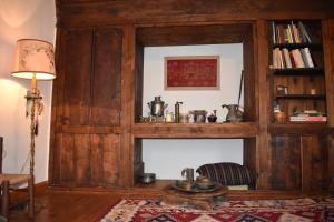 a fireplace in a living room with a wooden wall at The Doctor’s Mansion - Arkadia in Lagkadia