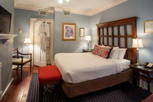a bedroom with a bed and a chair in it at The Marshall House, Historic Inns of Savannah Collection in Savannah