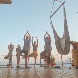 a group of people doing yoga on a deck at Native Residence in Rosarito