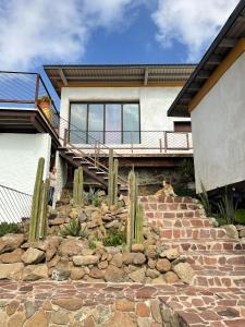 a house with a stone staircase with cacti at Native Residence in Rosarito