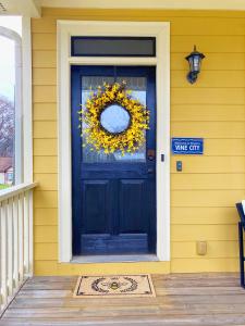 a black front door with a wreath on it at Vine City Bee Hive in Atlanta