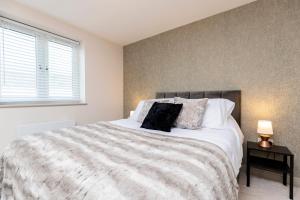 a bedroom with a large bed and a window at Avery House 2 - Two Bedroom with Outdoor Terrace by BPNE in Darlington