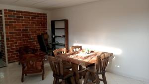 a dining room with a wooden table and chairs at Apartamento Amoblado en Ibagué in Ibagué