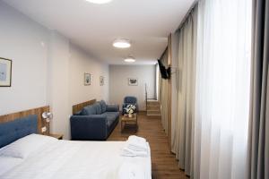 A bed or beds in a room at AquaSun Family Hotel