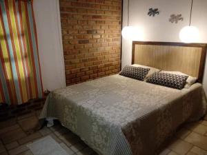 מיטה או מיטות בחדר ב-Vivenda Peixe Pequeno