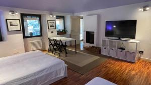 a bedroom with a bed and a table with a television at Cameloth B&B in Settimo Rottaro